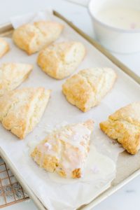 scones on baking sheet, white chocolate drizzle