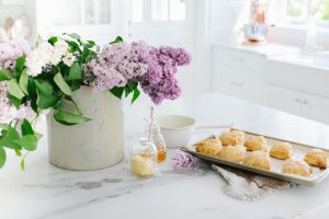 scones on counter with lilacs in crock