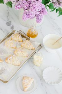 lilac scones on tray with drizzled icing