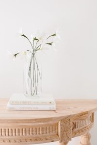 crepe paper daisy on wooden console table