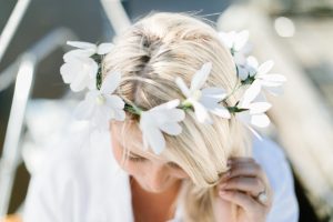 crepe paper daisy crown on blond hair
