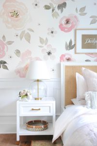 floral wall paper, lamp and nightstand