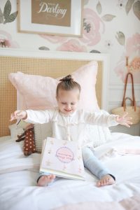 little girl happy on bed