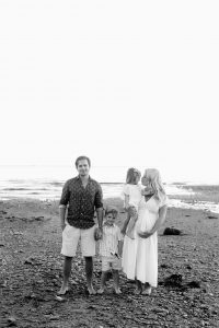 family photo on rocky beach