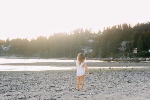 little girl pointing on beach