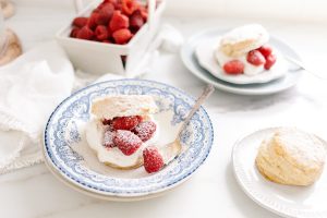 cornmeal shortcake, raspberries and cream in vintage bowl