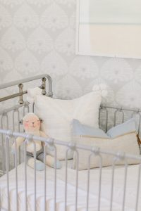 grey metal crib in nursery