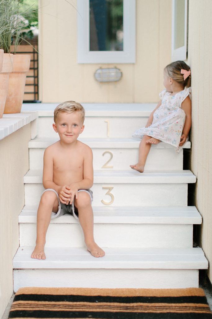 little boy on white steps