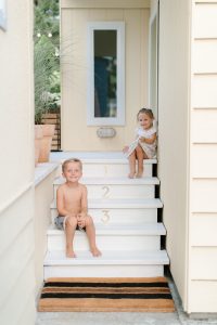 kids sitting on back porch steps in summer