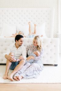family with new baby in master bedroom