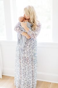 mom in blue and white maxi dress holding newborn