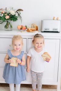 girls smiling by breakfast bar at home