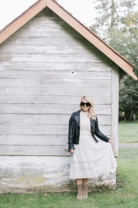 white dress with sunglasses and leather jacket