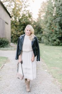 walking down country road in white dress and leather jacket
