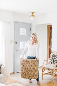 women in living room with wicker laundry basket