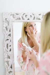 women dapping eye cream under the eye