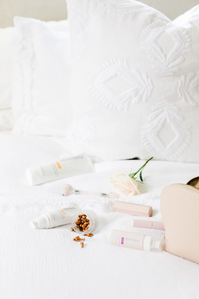 beauty products on white bed
