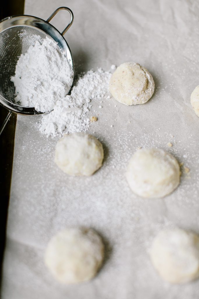 almond snowball cookies on baking sheet
