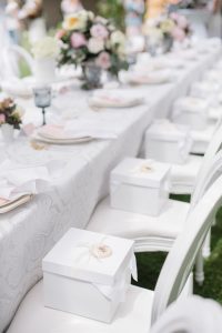 Pretty white boxes on white chairs long table dinner