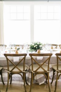 rustic wooden chairs around elegant party table decor