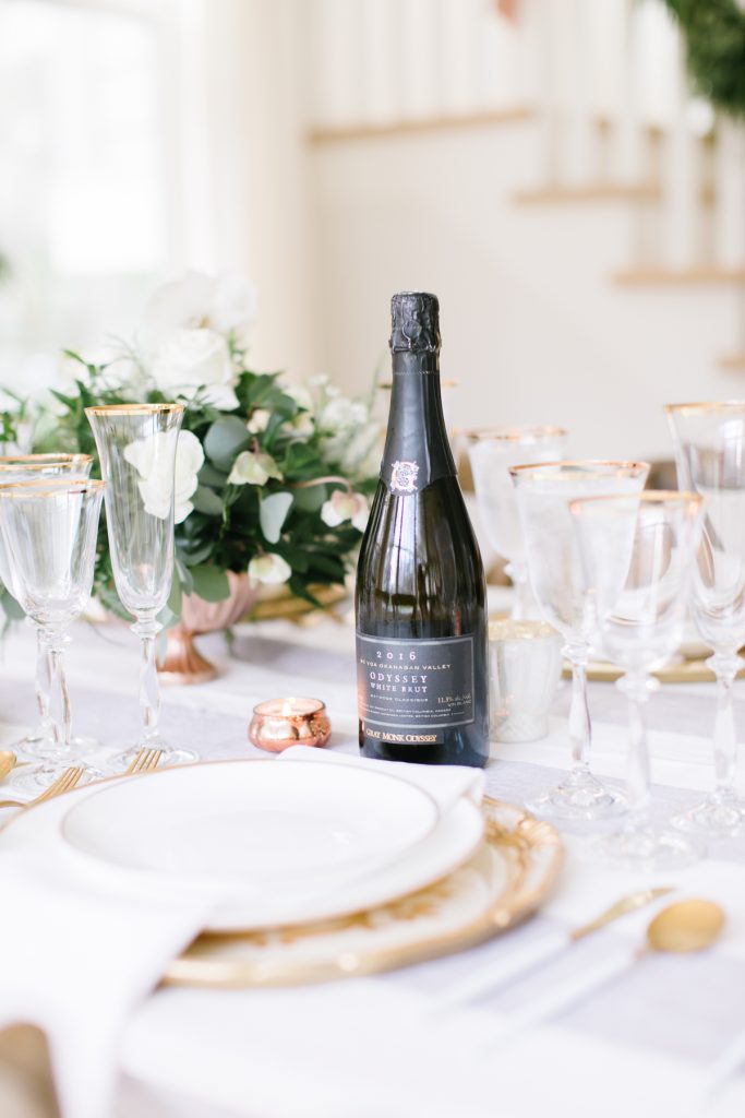 wine on a dining table with white and gold floral decor