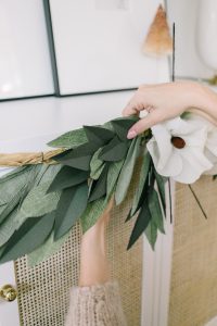 attaching magnolia flowers on garland