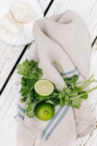 fresh lime and cilantro on linen napkin