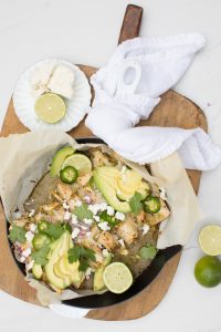 skillet filled with green chili enchiladas