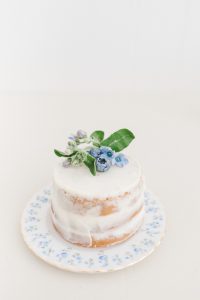 mini vanilla cake with small blue flowers and blueberries