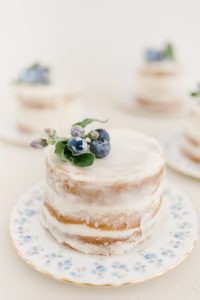 mini vanilla cakes with flowers and blueberries