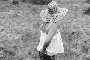 woman white baby doll tank and straw hat