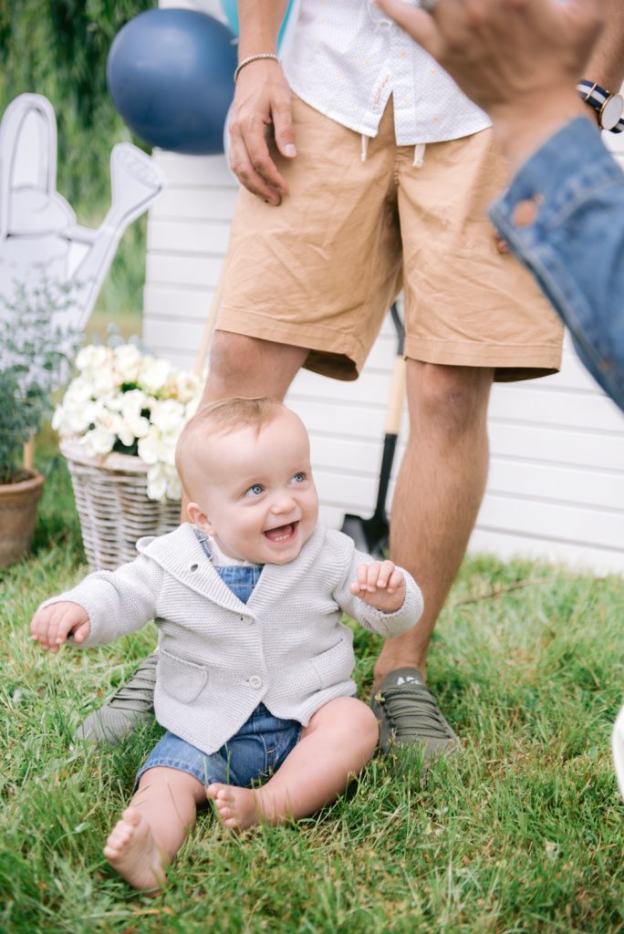 baby son blake smiling while sitting on grass