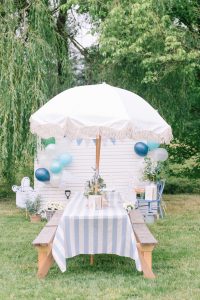 peter rabbit themed picnic tables with blue and white table clothes and umbrellas