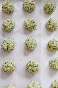 Loaded Green Chicken Meatballs Formed into Balls on Parchment Paper