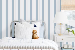 Little Boys Bedroom with Teddy Bear on the Bed and the #MHxUrbanWalls Wallpaper in Brighton Stripes in Blue