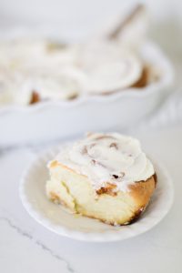 Piece of cinnamon bun with icing on top