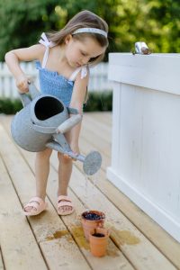 little girl watering plants