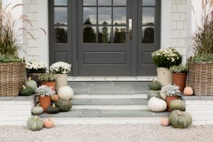 Monika Hibbs home exterior door, pumpkins and potted flowers on steps
