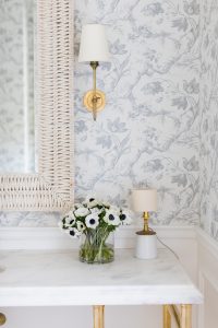 Wicker Mirror with Gold Sconce and Toile De Fleurs Wallpaper